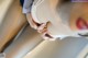 A close up of a woman putting on a bra.